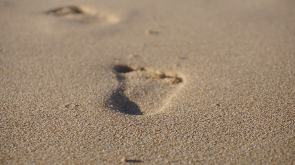 Fototapeta na wymiar child foot print on sand