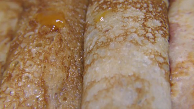 Tasty pancake rolls  with topping, homemade strawberry jam &ndash; detail, closeup