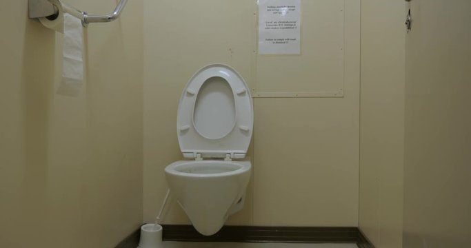 Wall hung toilet bowl in industrial lavatory