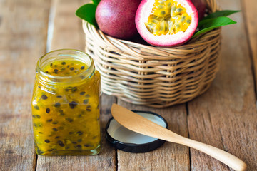Homemade passion fruit jam in bottle put on wood table. Passion fruit jam background with copy...