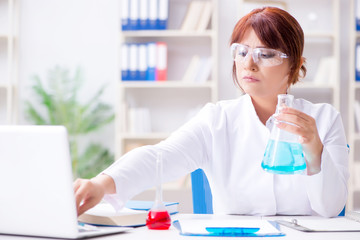 Female scientist researcher conducting an experiment in a labora