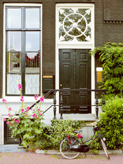 Fototapeta na wymiar The door, the porch, the Dutch windows, the facade of the house, bicycles, Amsterdam.