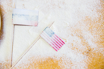 Russian and USA flags on the floured table