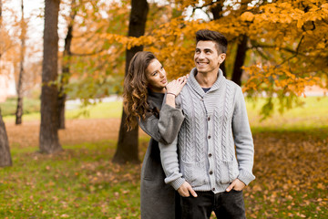 Lovely young couple in the autumn forest