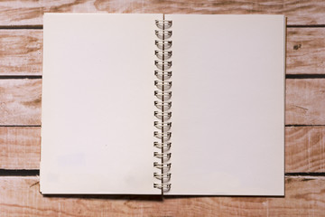 Opened notepad on top of a wooden board