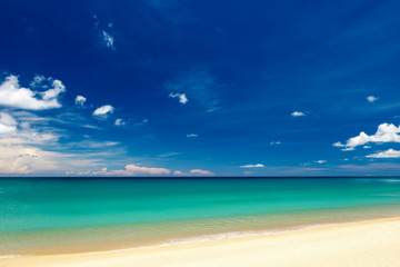 Fototapeta na wymiar Beautiful beach with blue sky at Mai khao beach, Phuket, Thailand.