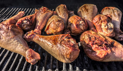 Juicy pieces of of roasted turkey legs  on the grill