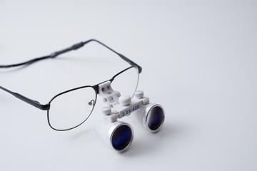 Close up of medical loupes / magnifying glasses on white background