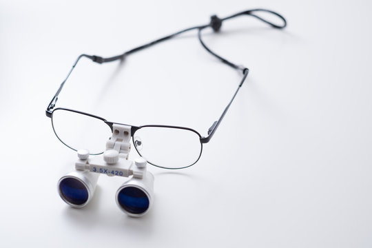 Close up of medical loupes / magnifying glasses on white background
