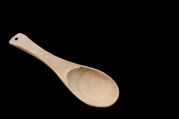 wooden scoop on black background