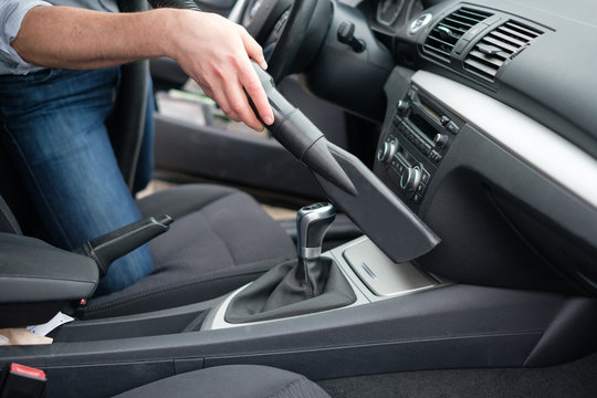 Man Vacuum Cleaning His Car