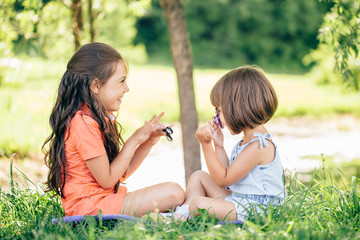 funny friends playing with colorful fidget spinners on the playground