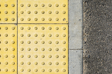 Adjoining Pavement with a Tactile Tile for Blind Peoples and an Asphalt Road. Joint of Road...