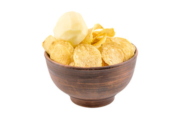 Bowl with potato chips and raw potato isolated on white.