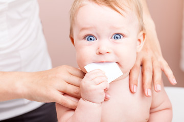 Baby in doctors office receiving osteopathic treatment of shoulders