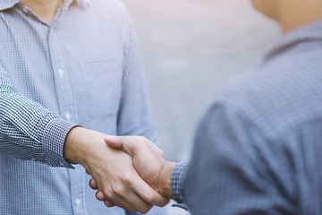 Closeup of a business man hand shake between two colleagues greet , Represents Friendship is good,success, congratulations. copy leave space for text.