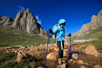 Young woman with backpack walking on mountain
