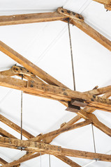 Wooden Roof Structure in White Bright Interior. Old Rafters in the Loft Interior
