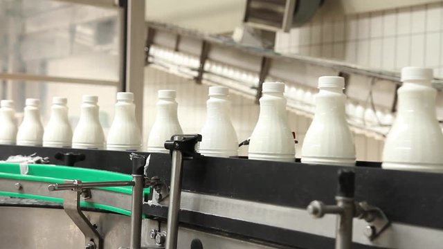 Footage of plastic milk bottles at the production line in a milk factory...