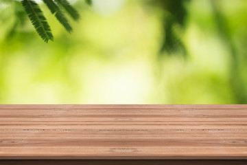 Wood table top on nature green blurred background,for montage your products