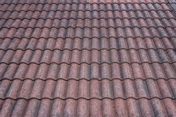 Fototapeta premium The top red roof tiles over a long period of time make the paint pale.