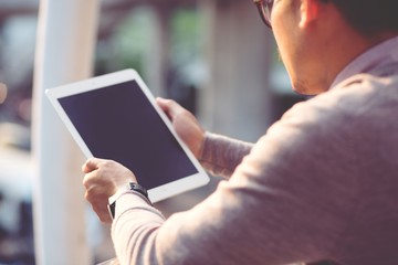 Rear view Business man using tablet