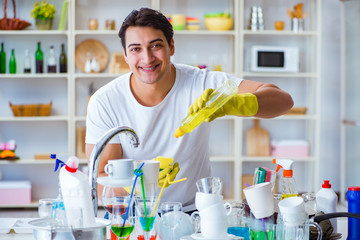 Man enjoying dish washing chores at home