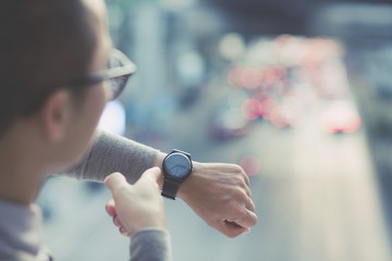 The young man looked at the watch on the road.