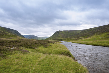 Fototapeta na wymiar View of a river in the Highlands of Scotland in United Kingdom in an overcast day; Concept for travel in Scotland
