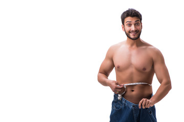 Man in dieting concept with oversized jeans