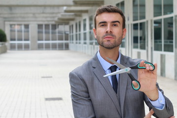 Businessman holding a pair of scissors