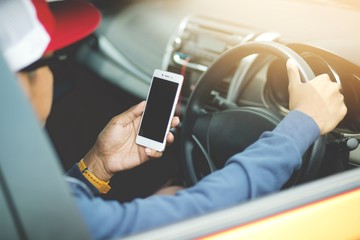 Young man put on a driving car and using  smart phone mobile phone.