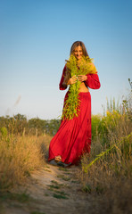 cheerful rural girl in red dress.