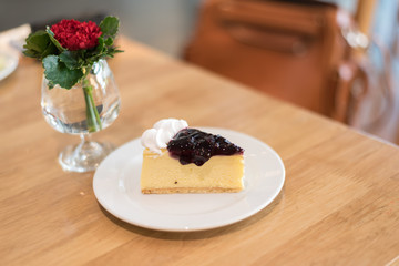 blueberry cheese cake on plate in cafe