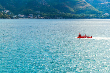 Sea view from the mountain. Adriatic Sea. A stylized red submarine floats by the sea. Montenegro