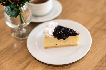 blueberry cheese cake on plate in cafe