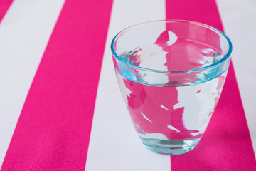 Glass of water on a tablecloth