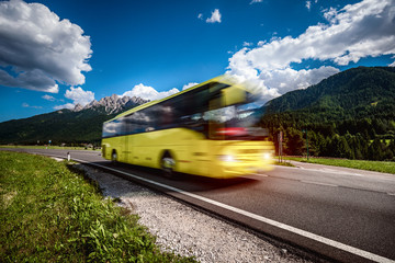 Yellow Public bus traveling on the road