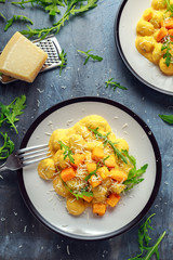 Homemade Butternut squash gnocchi with wild rocket and parmesan cheese