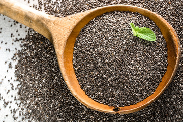 Healthy food - omega-3 source - macro of chia seed, overhead over wooden spoon