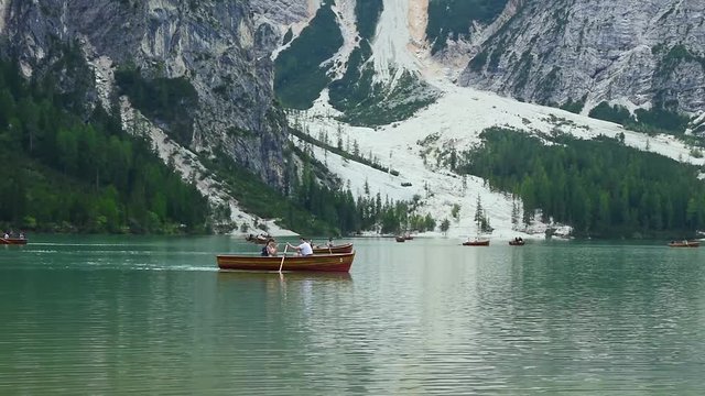 Tourists in boats on the Lake Braies, South Tyrol, Italy
