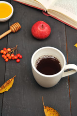 Autumn still life cup of tea, honey and book on the table