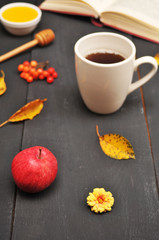Autumn still life cup of tea, honey and book on the table