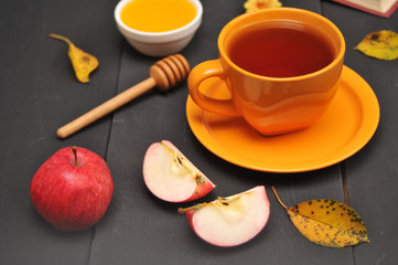 Autumn still life cup of tea, honey and book on the table