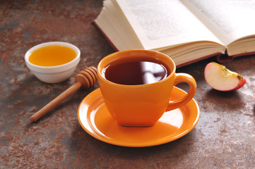 Autumn still life cup of tea, honey and book on the table