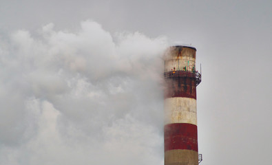 Smoke stack polluting the air by thowing chemicals in the atmosphere