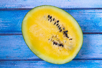Yellow watermelon on a wooden background