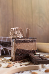 chocolate cake slice with chocolate cream and chocolate bar. cake background concept