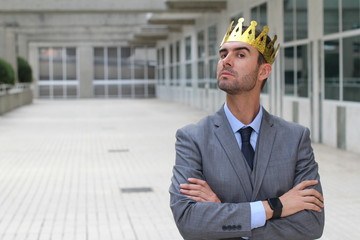 Arrogant businessman with a crown in office space  - obrazy, fototapety, plakaty