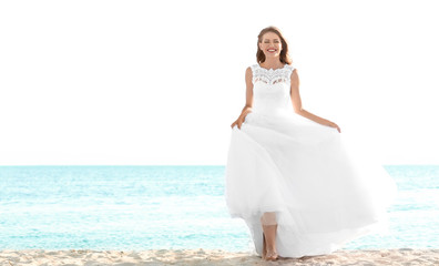 Fototapeta na wymiar Happy young bride on sea beach